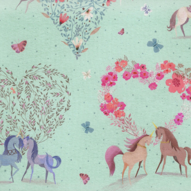 aqua fabric featuring scattered darker aqua stars and butterflies amidst whimsical unicorns with floral hearts