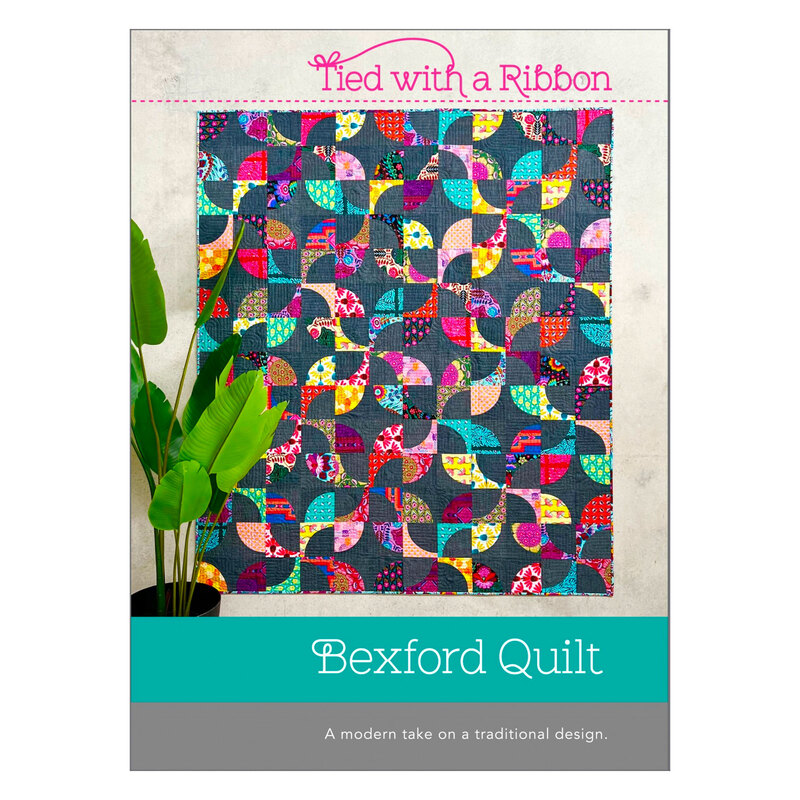 Bexford Quilt Pattern front featuring a sample of the quilt in bright colors contrasting with a denim blue