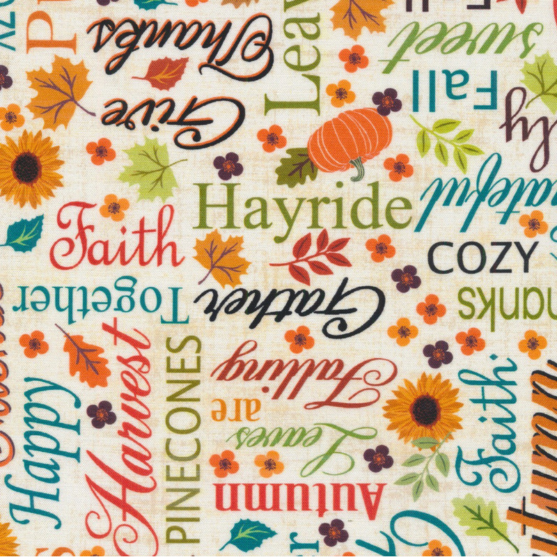 cream fabric featuring a lovely array of varying fonts and colors of autumnal words and sayings, interspersed with fall leaves, pumpkins, and flowers