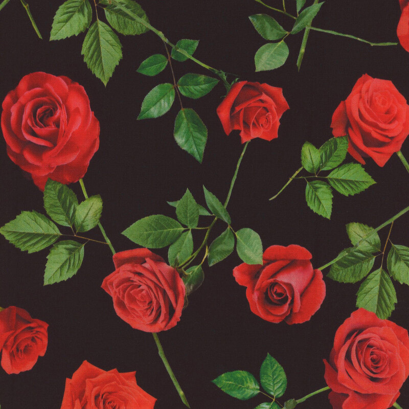 black fabric featuring scattered single bright red roses with accompanying leaves