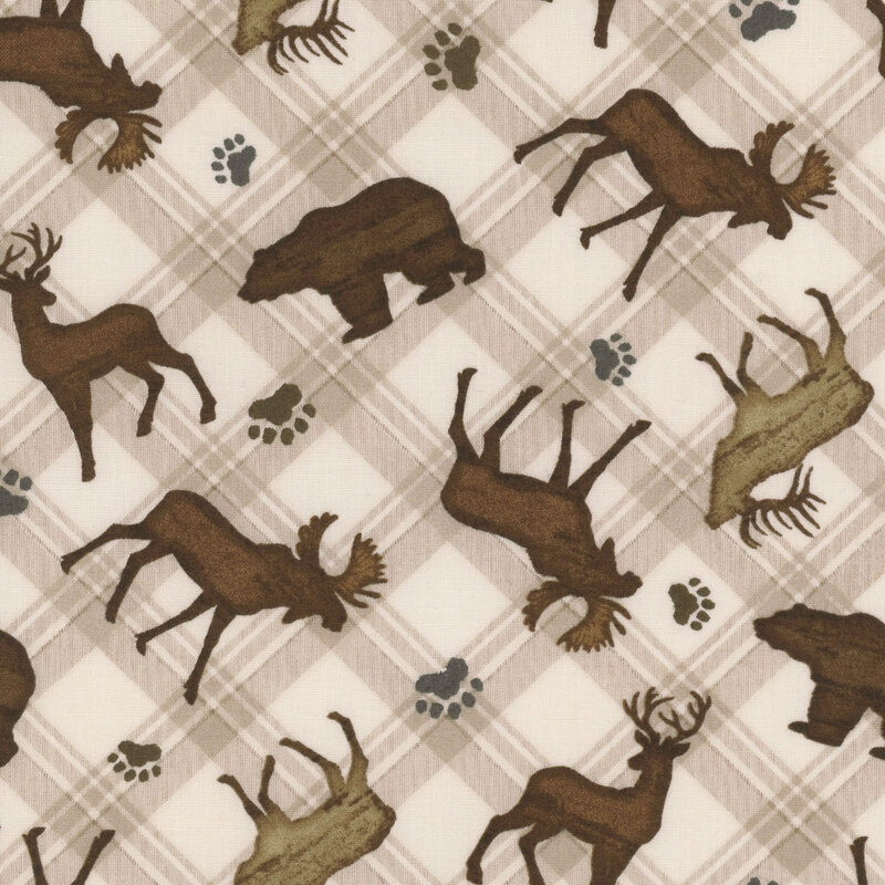 Cream fabric featuring scattered moose, elk, deer, and bears with paw prints on a plaid background.