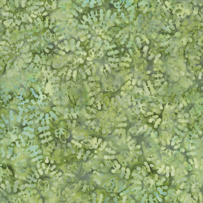 light green batik fabric featuring tonal mottling and a lighter mottled swirling vine pattern