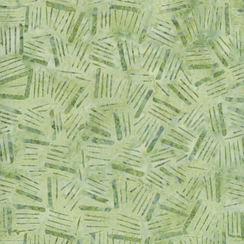 light green batik fabric featuring tonal mottling and darker green mottled dashes across the fabric