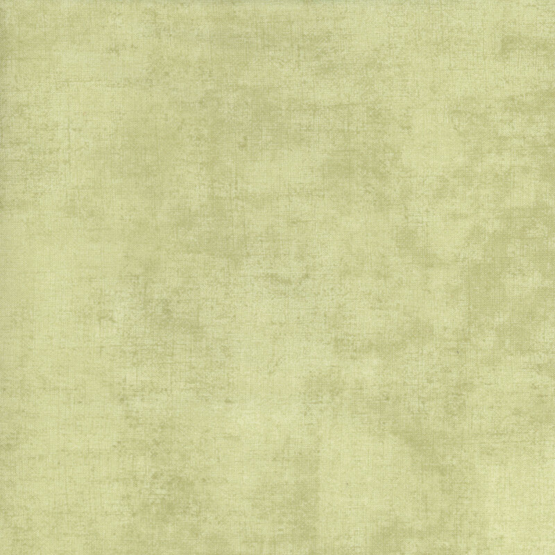 fabric featuring a beautiful muted light green dry brush texture on a pastel green background