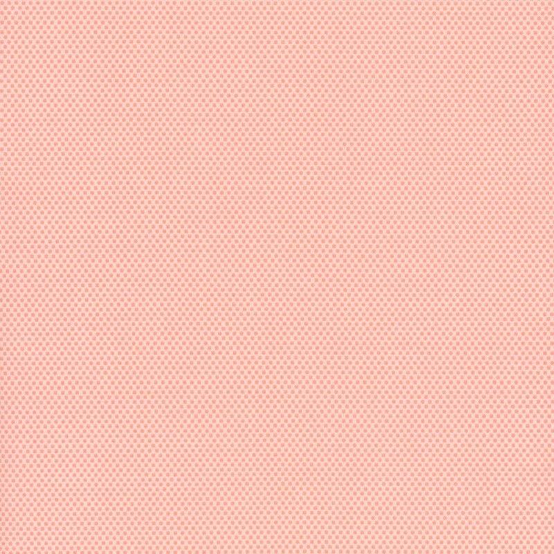 light pink fabric with darker tonal small pink polka dots across it