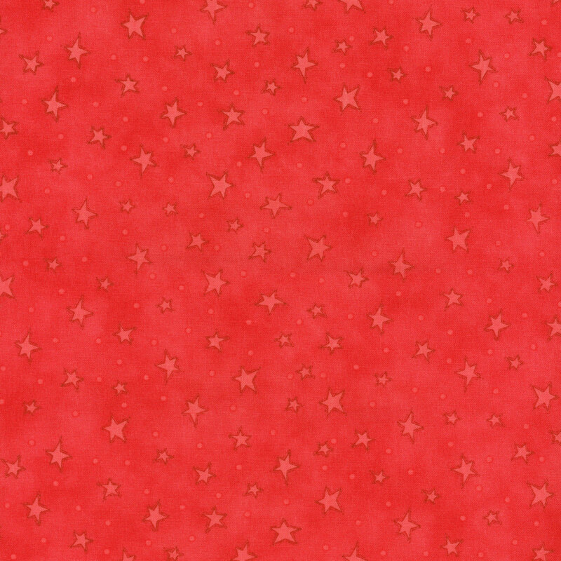 mottled red fabric with scattered ditsy stars and tonal speckles