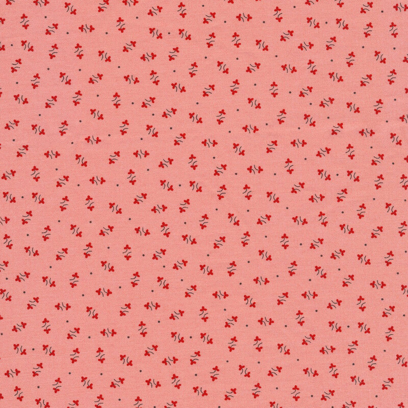 bubblegum pink fabric featuring a red floral ditsy pattern, with small scattered black dots interspersed throughout