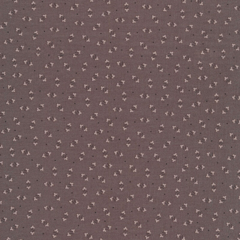 gray fabric featuring a white floral ditsy pattern, with small scattered black dots interspersed throughout
