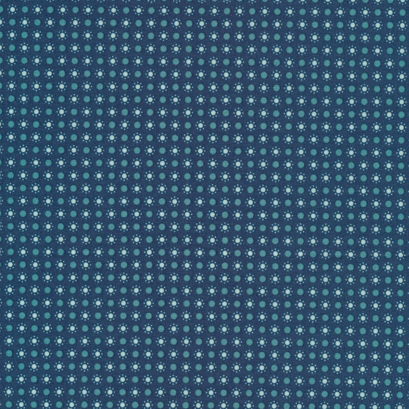 denim blue fabric featuring light blue polka dots with a circle of smaller dots around them and teal polka dots in between