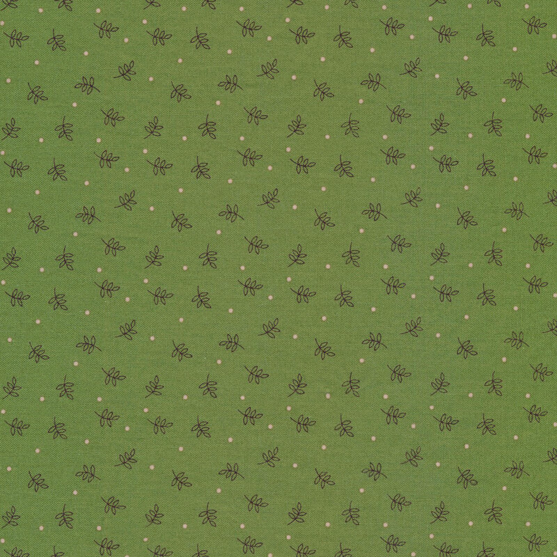 green fabric featuring scattered green leaves and white dots