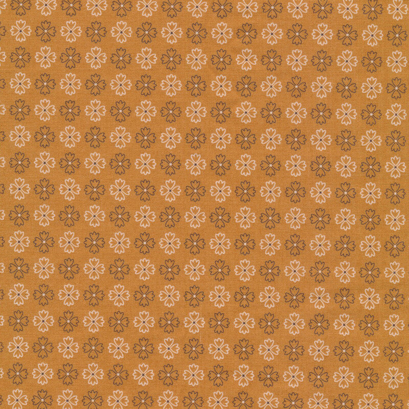 golden fabric featuring rows of alternating brown and cream flower outlines