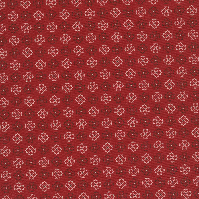 bold red fabric featuring rows of alternating black and white flower outlines
