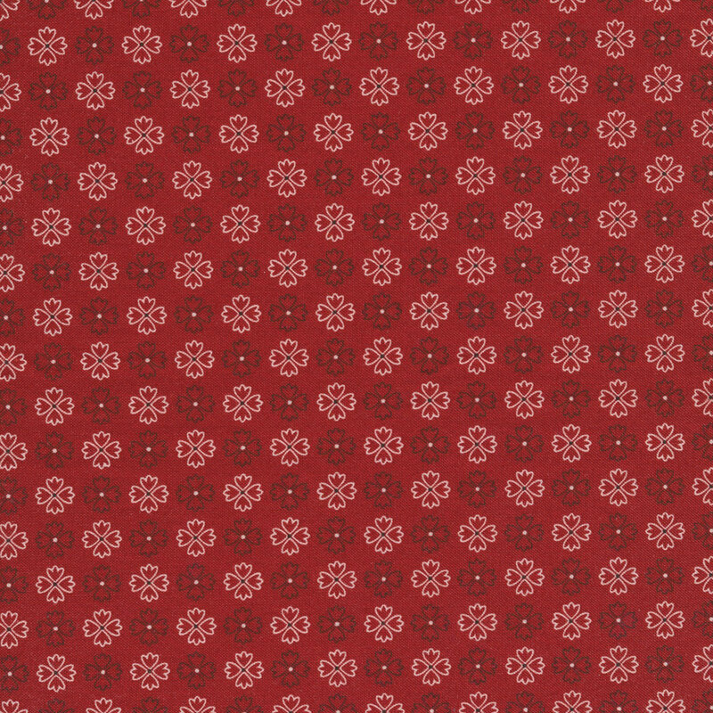 bold red fabric featuring rows of alternating black and white flower outlines