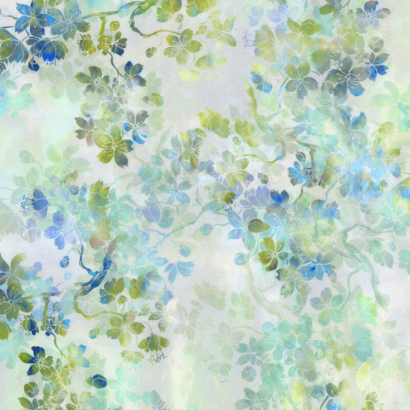 off white fabric featuring layers of mottled green and blue flowering branches