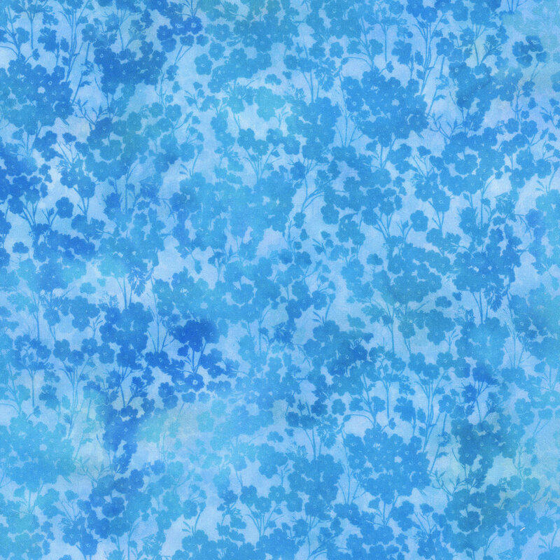 mottled light blue fabric featuring packed small blue tonal flowers