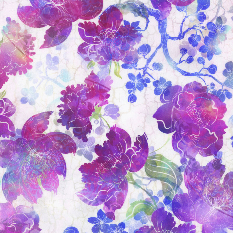 cream fabric featuring a crackled background with mottled blue blossoming branches and vivid mottled flowers in shades of purple, magenta, and blue