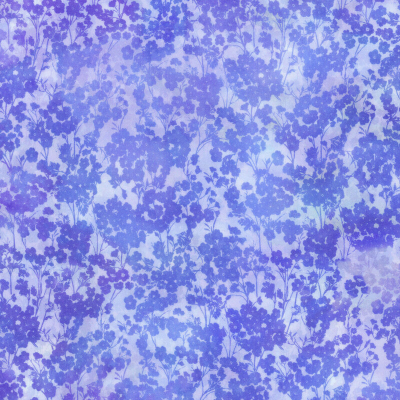 mottled purple and blue fabric featuring packed small blue tonal flowers