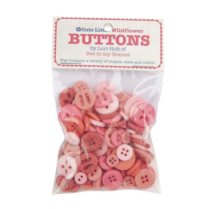 A pack of pink buttons in a small plastic package