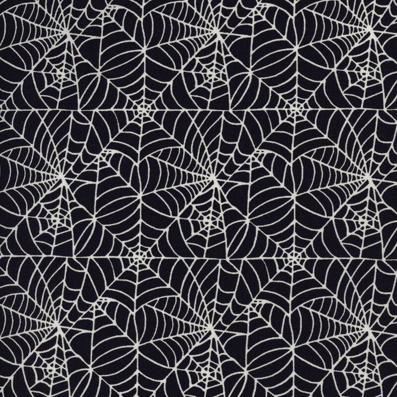 Black fabric featuring a delicate and intricate white spiderweb design