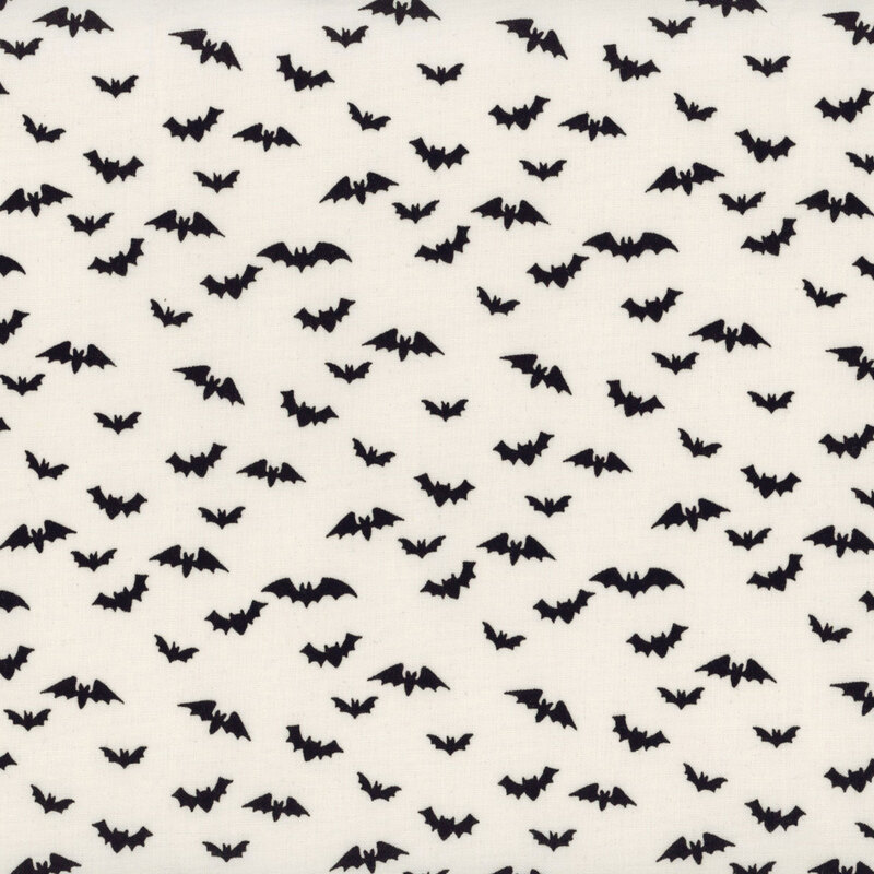 Cream fabric featuring scattered flying black bats.