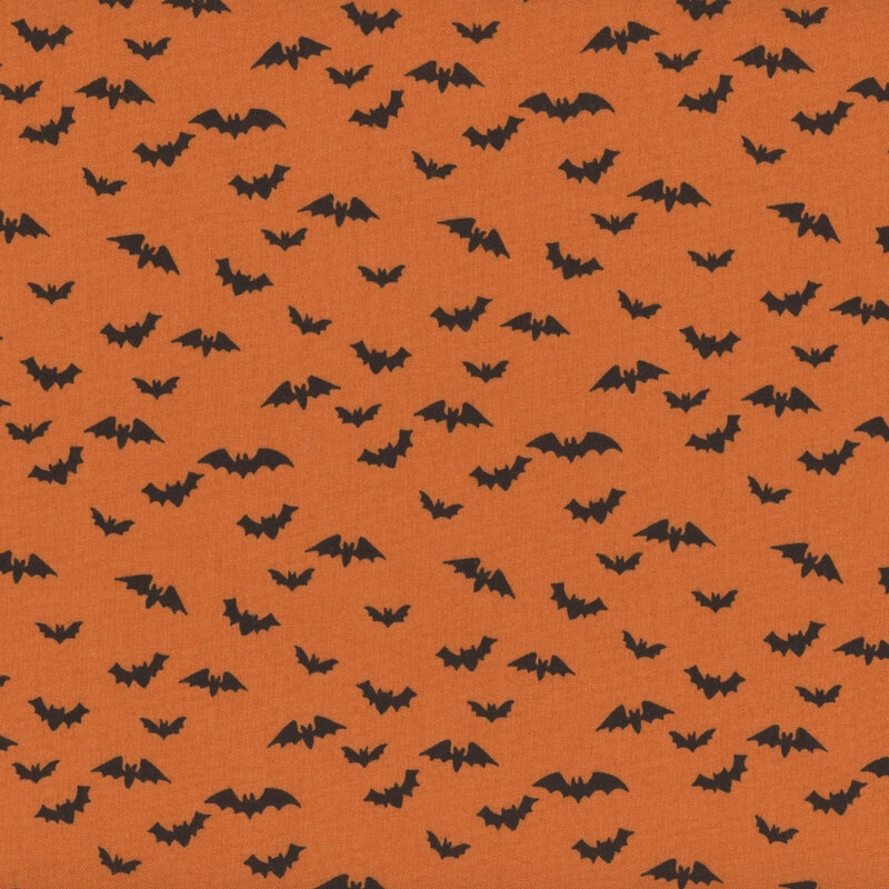 Orange fabric featuring scattered flying black bats.
