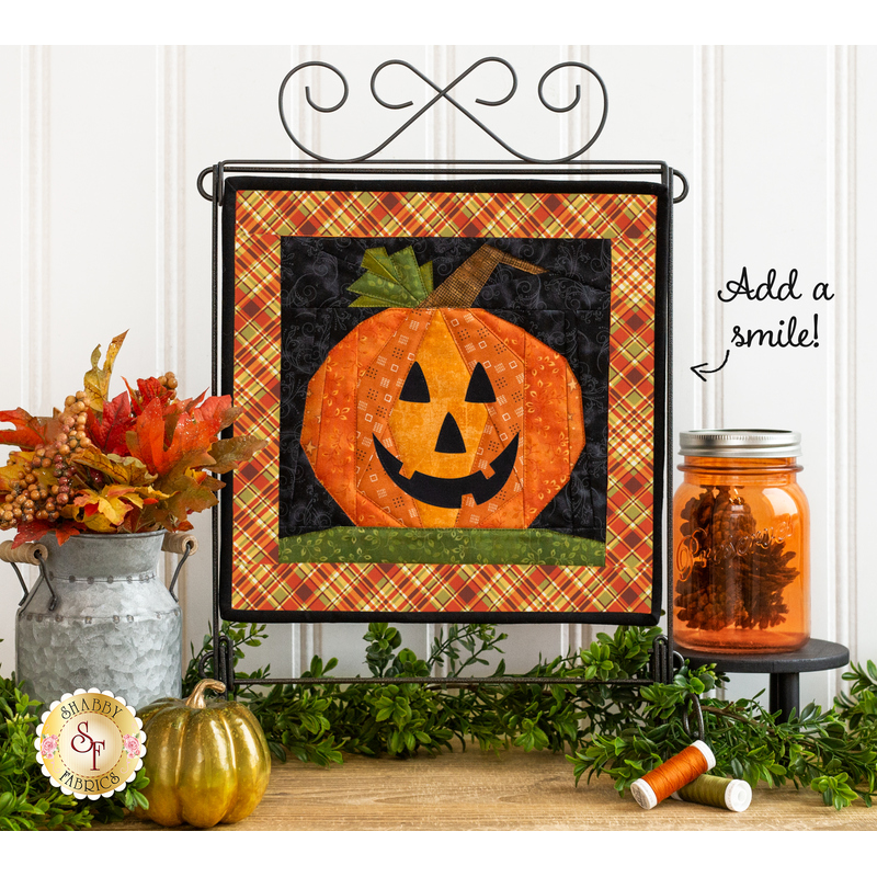 A Foundation Paper Piecing October Wall Hanging that has a Jack-O-Lantern Face.