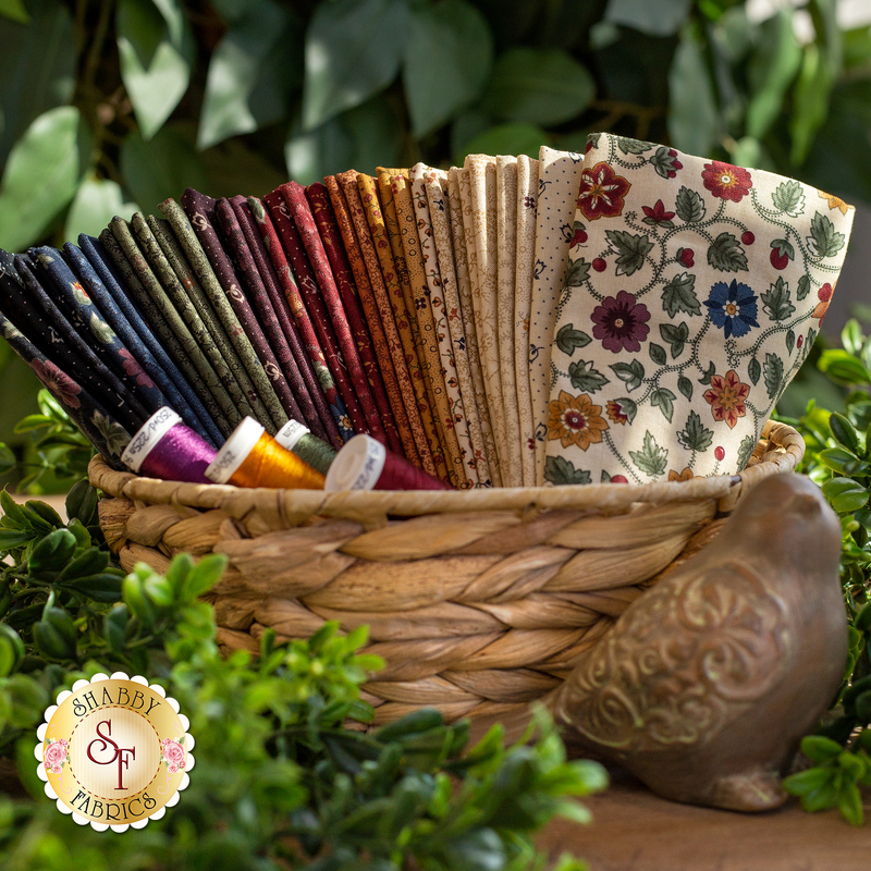 stack of floral earth-toned fabrics in a natural water hyacinth basket including 34 fat eighths from the Chickadee Landing collection