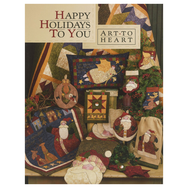 Front cover of the happy holidays to you pattern book displaying multiple holiday projects including a quilt, pillows, wall hangings, table runners, pot holders, and more