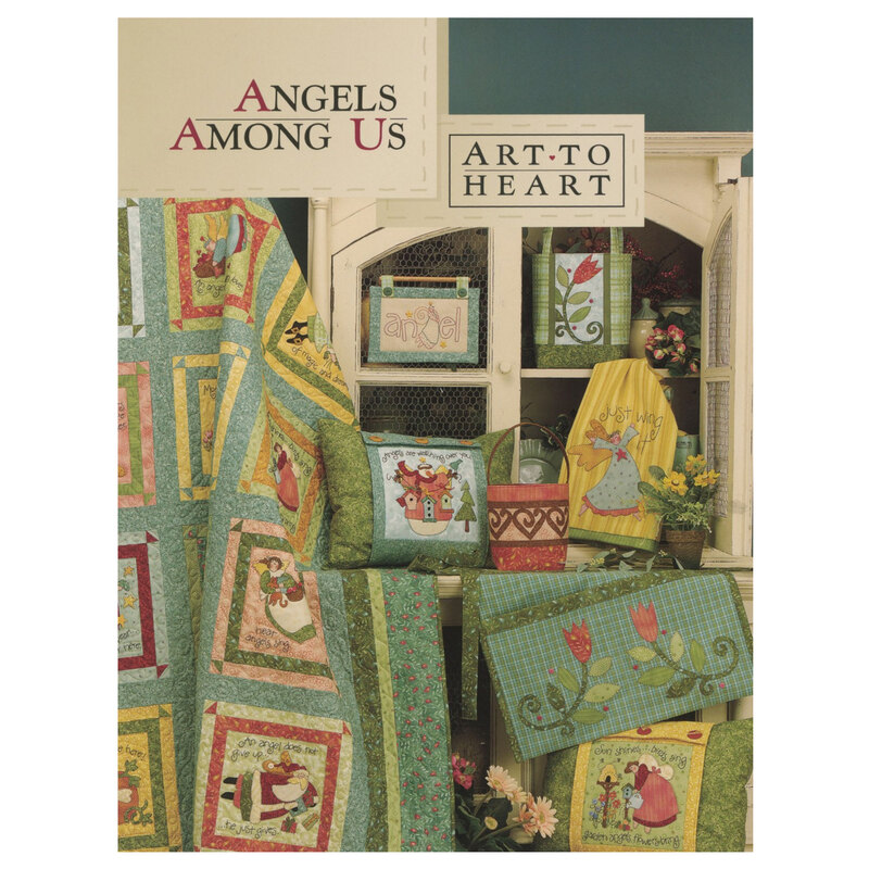 Front cover of the angels among us pattern book displaying multiple angel themed projects including a quilt, pillow, wall hangings,  table runner,  a tote bag, and other projects