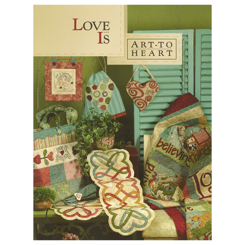 Front cover of the love is pattern book displaying multiple quilting projects including a quilt, wall hangings, table runners, pot holders, napkins, bags, and more