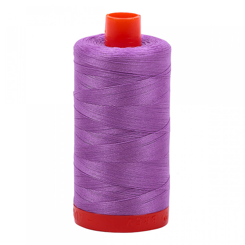 A spool of Aurifil 2520 - Violet thread on a white background