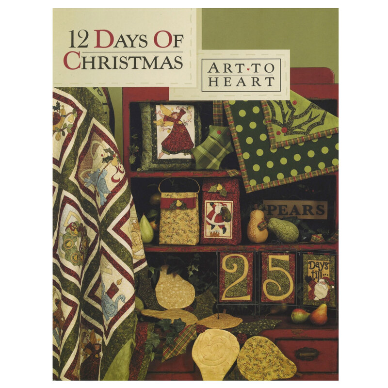 Front cover of the 12 Days of Christmas pattern book displaying multiple holiday projects including a quilt, pillows, wall hangings, table runners, pot holders, and more