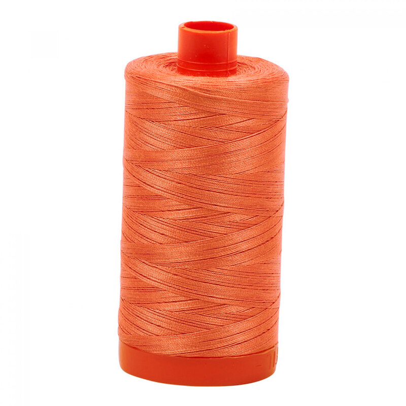 A spool of Aurifil 6729 - Tangerine Dream thread on a white background