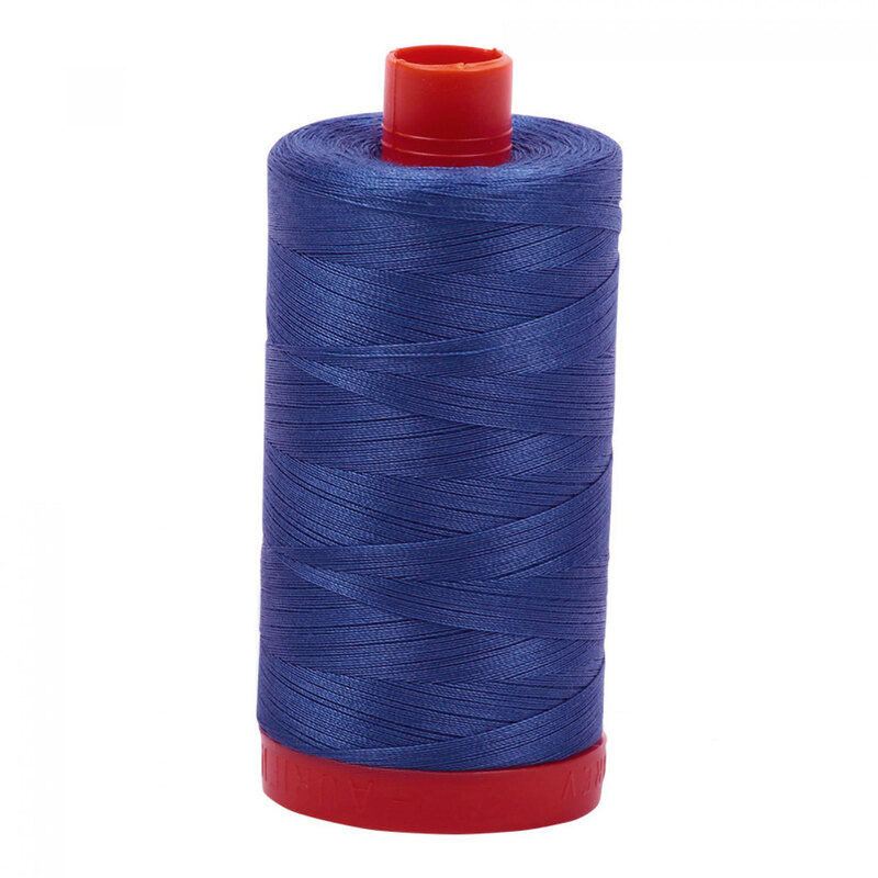 A spool of Aurifil 6738 - Peacock Blue thread on a white background