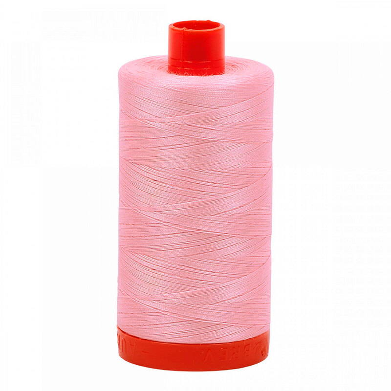 A spool of Aurifil 2423 - Baby Pink thread on a white background