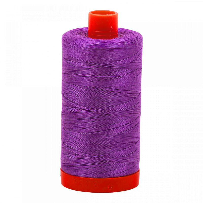 A spool of Aurifil 2540 - Medium Lavender thread on a white background