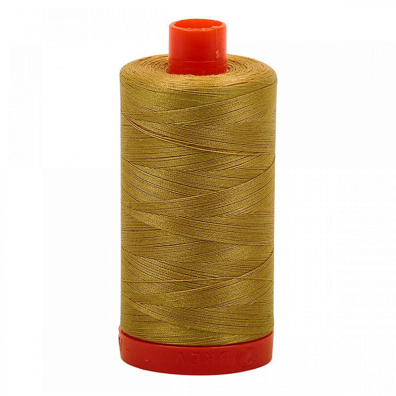 A spool of Aurifil 2920 - Light Brass thread on a white background