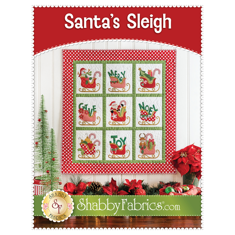 Front cover of the Santa's SLeight Quilt pattern showing a photo of the finished project hanging on a wall with Christmas decor all around, and designer information