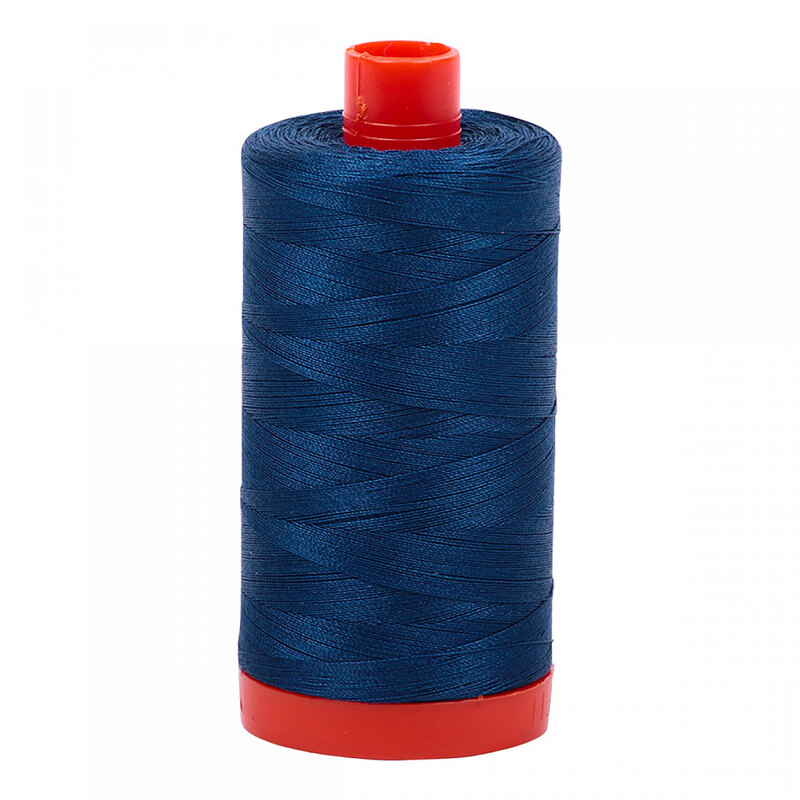 A spool of Aurifil 2783 -Medium Delft Blue thread on a white background