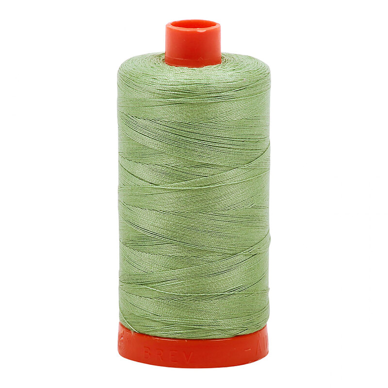 A spool of Aurifil 2840 -Loden Green thread on a white background