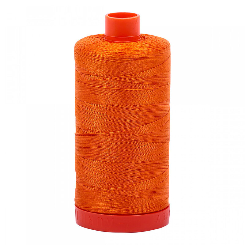 A spool of Aurifil 1133 -Bright Orange thread on a white background