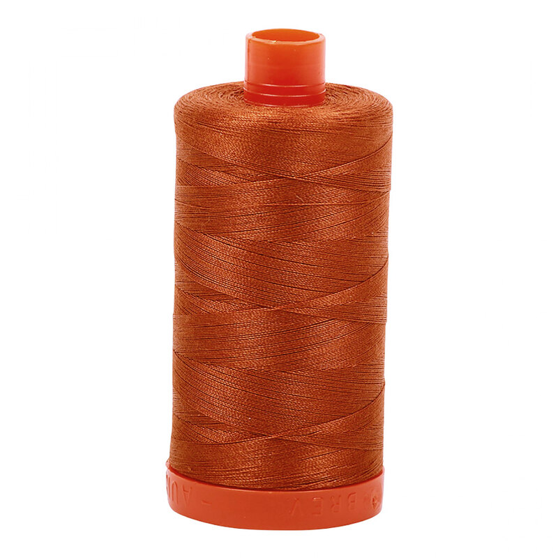 A spool of Aurifil 2390 -Cinnamon Toast thread on a white background