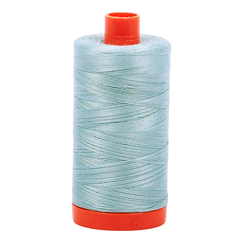 A spool of Aurifil 2847 -Bright Grey Blue thread on a white background
