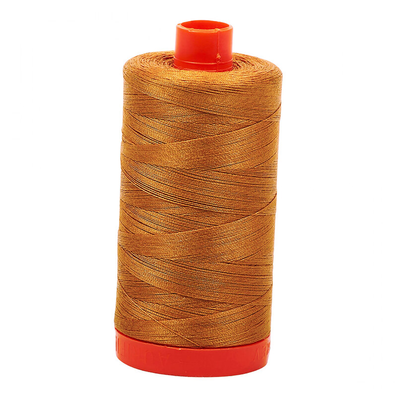 A spool of Aurifil 2930 -Golden Toast thread on a white background