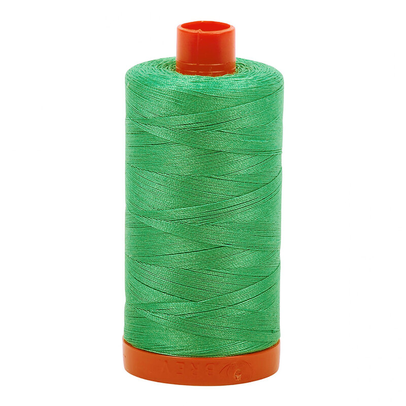A spool of Aurifil 2860 -Light Emerald thread on a white background