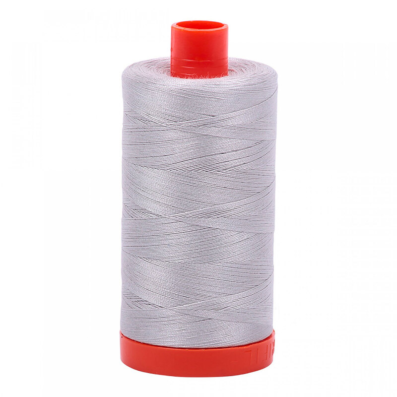 A spool of Aurifil 2615 -Aluminium thread on a white background