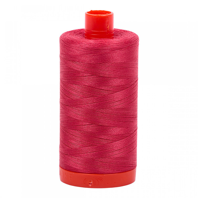 A spool of Aurifil 2230 -Red Peony thread on a white background