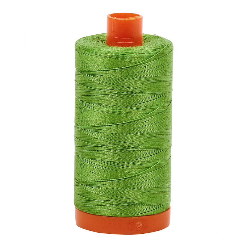 A spool of Aurifil 1114 -Grass Green thread on a white background