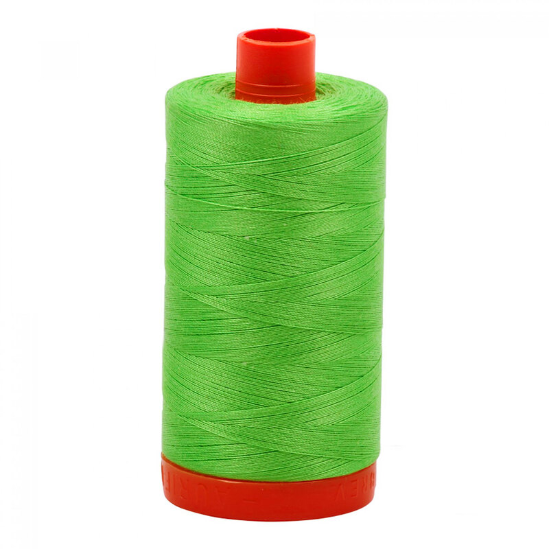 A spool of Aurifil 6737 -Shamrock Green thread on a white background