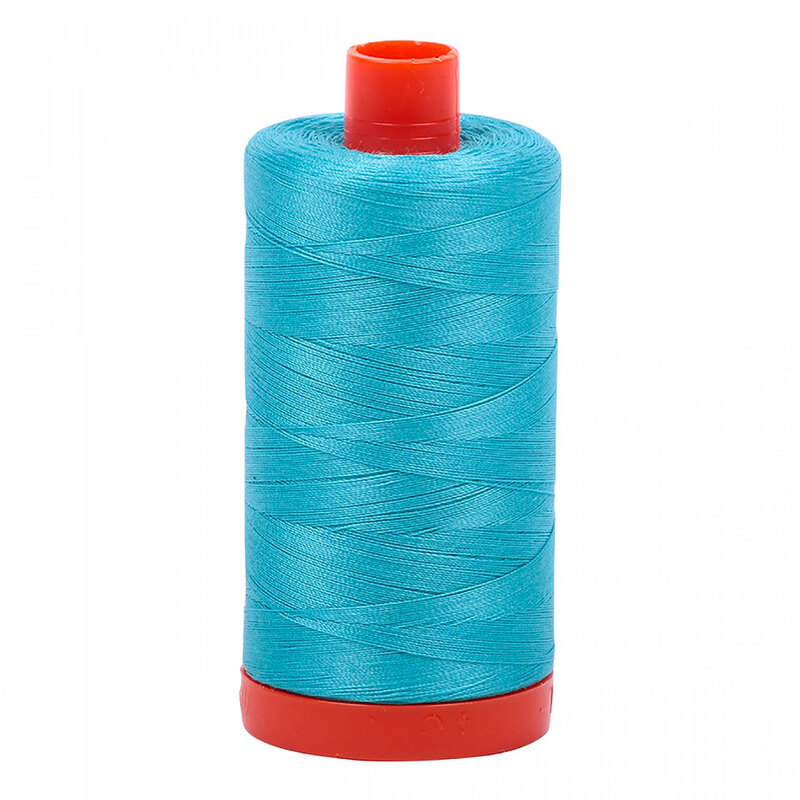 A spool of Aurifil 5005 -Bright Turquoise thread on a white background